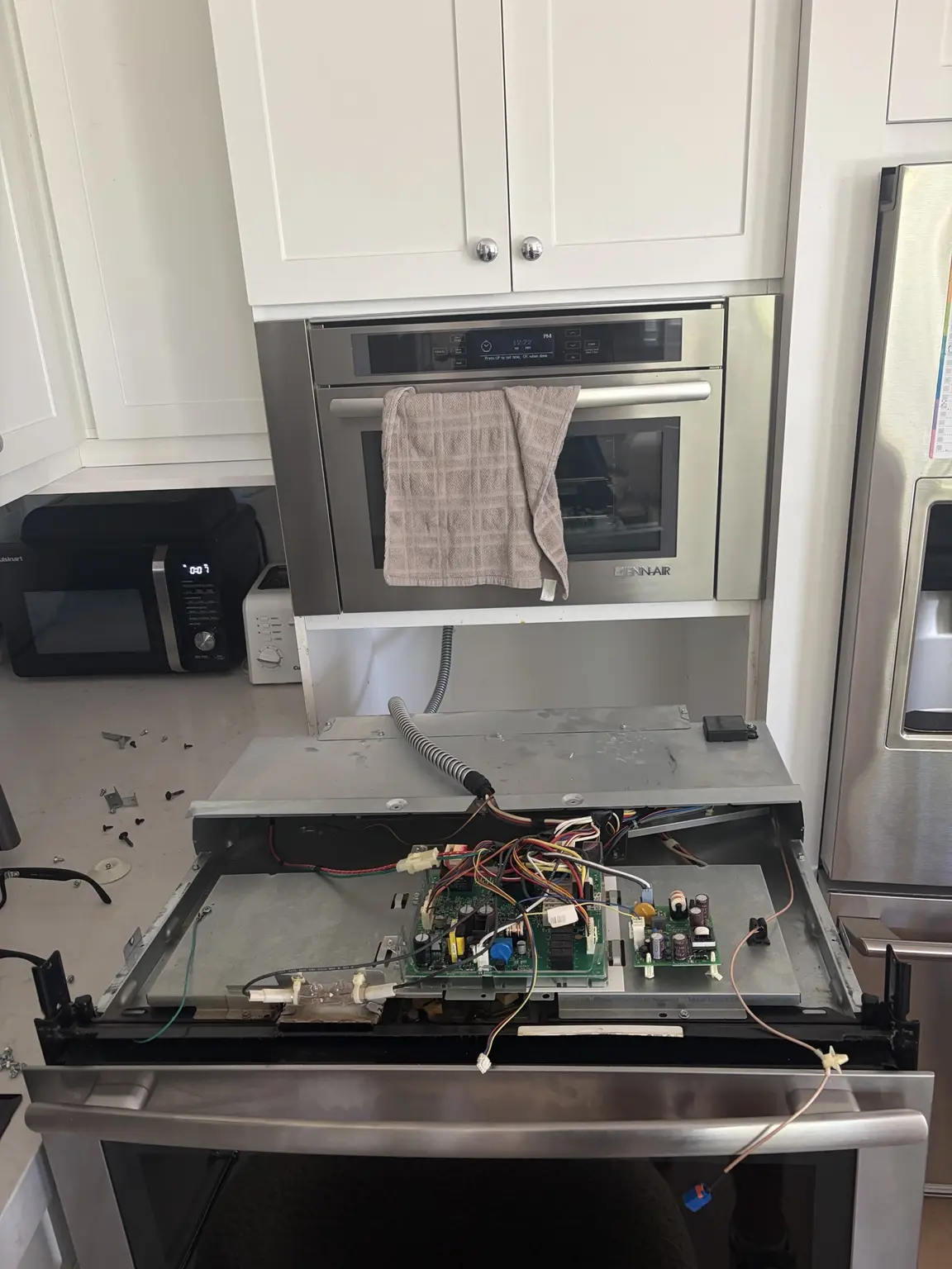 JennAir wall oven removed from cabinet to access internal fuse during repair in Weston
