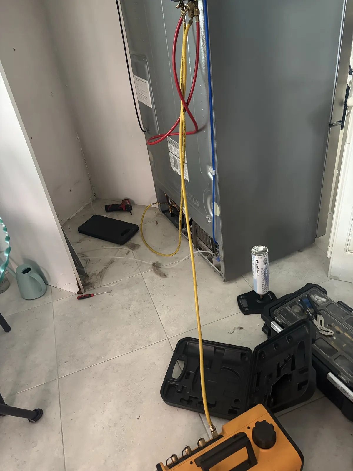 Refrigeration service hoses and equipment connected to an LG refrigerator during compressor replacement in Deerfield Beach