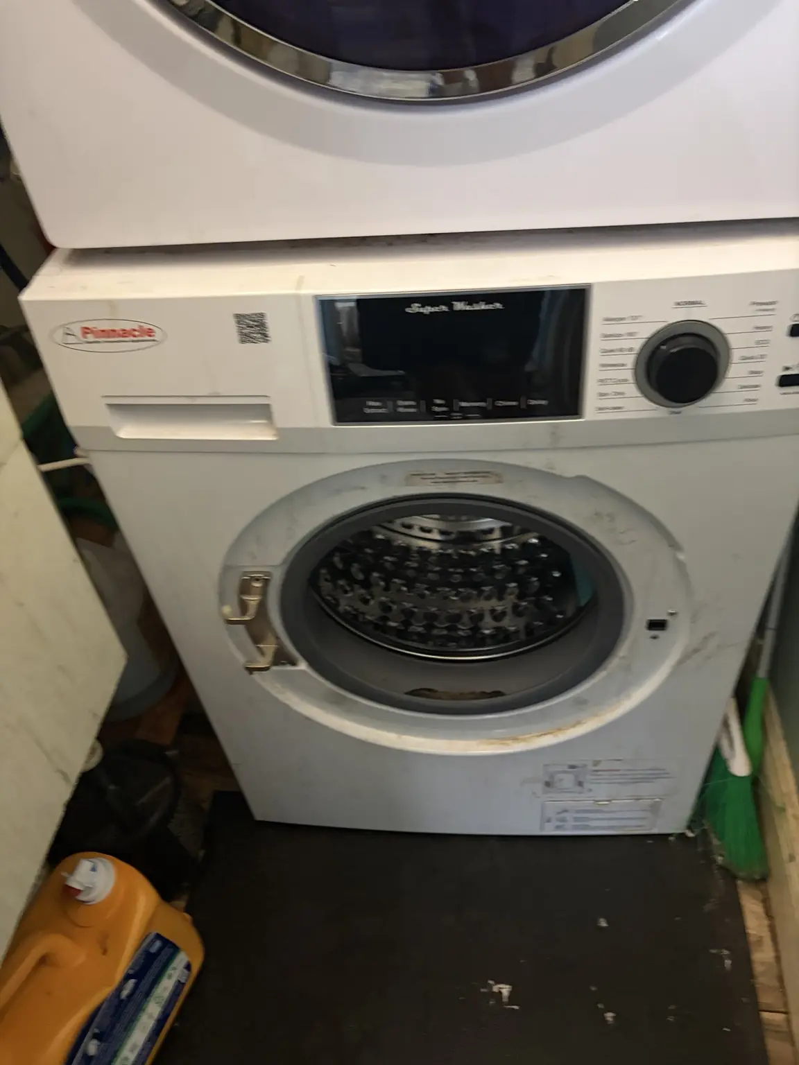 Pinnacle front-load washer with the damaged door removed before replacement in Delray Beach