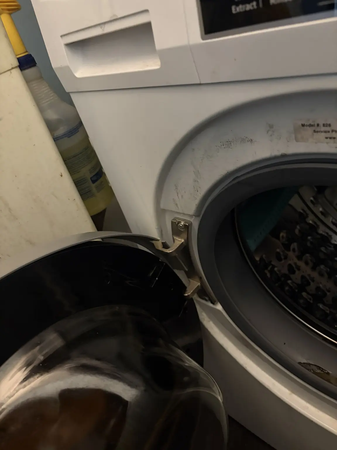 Close view of the Pinnacle washer door hinge during replacement
